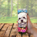 Close-up of sublimation details—no vinyl. woman enjoying her favorite drink in a custom Bichon tumbler while sitting outside